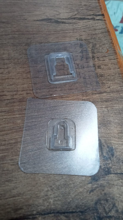A set of GlimmerHome transparent self-adhesive wall hooks in packaging.